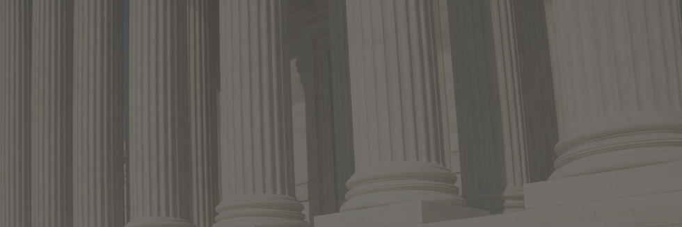 Close-up of classical columns, likely from a courthouse or similar building serving as a background for a promotion.